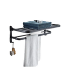 Black metal towel rack with towels.