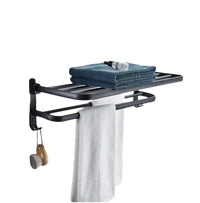 Black metal towel rack with towels.