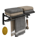 Black metal towel rack with towels.