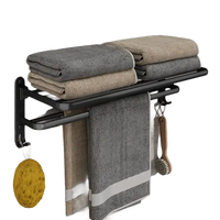 Black metal towel rack with towels.