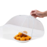 Mesh food cover over muffins.