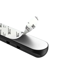Black cable organizer with adhesive backing.