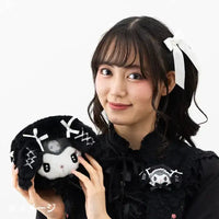 Young woman holding a Kuromi plush.