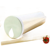 Cylindrical pasta container with a light green lid.