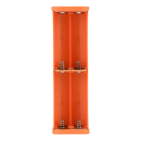 Orange battery holder with springs.