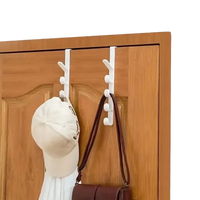 Over-the-door coat rack with hanging accessories.