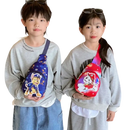 Two children wearing Paw Patrol sling bags.