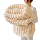 Cream-colored, plush, ribbed blanket.