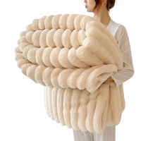 Cream-colored, plush, ribbed blanket.