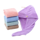 Stack of colorful towels and a purple hair towel wrap.