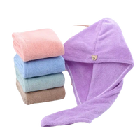 Stack of colorful towels and a purple hair towel wrap.