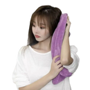 Woman drying hair with purple towel.