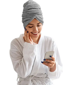 Woman in bathrobe with hair towel.