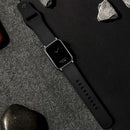 Black smart watch with leather band.