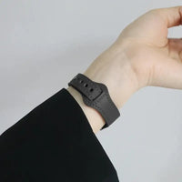 Gray leather wristband.