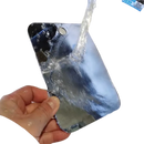 Shiny, reflective phone under running water.