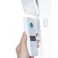 White remote control with blue button and screen, designed for Magnetix Wall Hooks wall mount strong magnet system