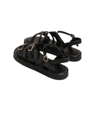 Black buckled platform sandals.