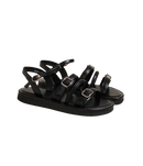 Black buckled platform sandals.