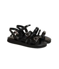 Black buckled platform sandals.