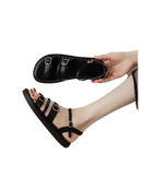 Black buckled sandal.