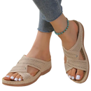 Beige perforated criss-cross sandals.