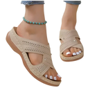 Beige perforated criss-cross sandals.