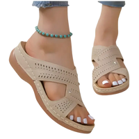 Beige perforated criss-cross sandals.
