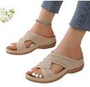 Beige perforated slide sandals.
