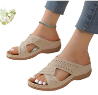 Beige perforated slide sandals.