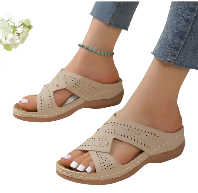Beige perforated slide sandals.