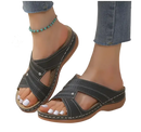 Black criss-cross slide sandals.