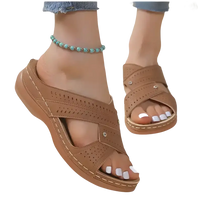 Brown perforated criss-cross sandals.