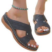 Gray perforated wedge sandals.