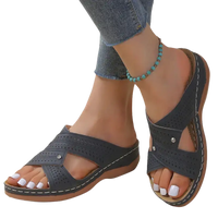 Gray perforated criss-cross sandals.
