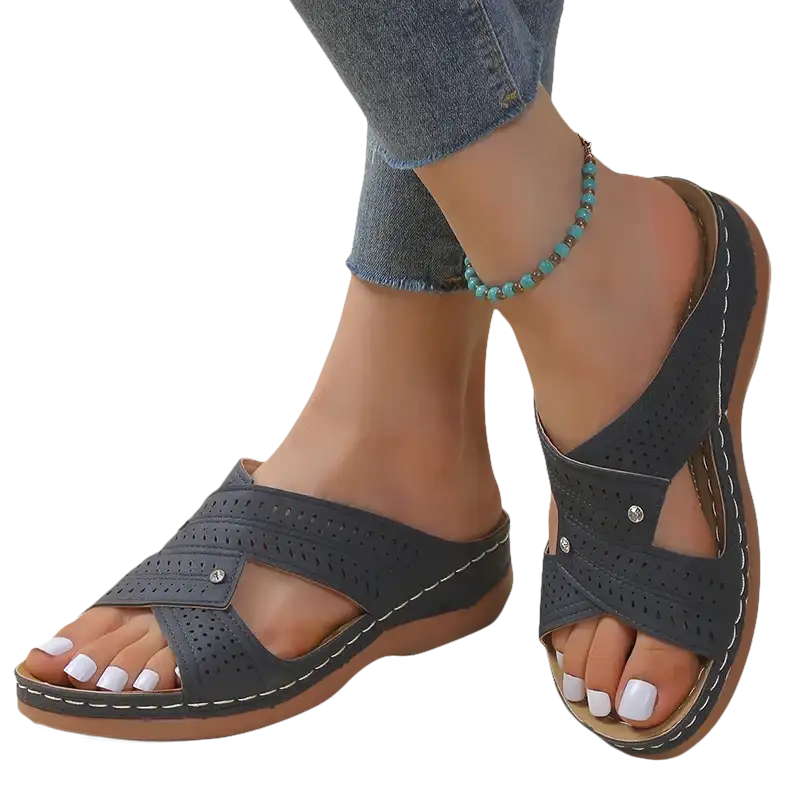 Gray perforated criss-cross sandals.