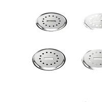 Black surface with four circular, perforated, metal fixtures.