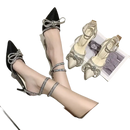 Elegant high-heeled shoes with rhinestone bows and ankle straps.