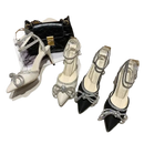 Elegant high-heeled shoes with rhinestone bows.