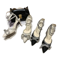 Elegant high-heeled shoes with rhinestone bows.
