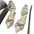 Rhinestone-embellished high-heeled shoes.
