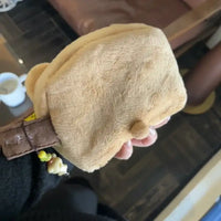 Tan plush coin purse.