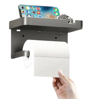 Gray toilet paper holder with shelf.