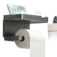Gray toilet paper holder with shelf.