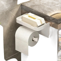 White toilet paper holder with shelf.