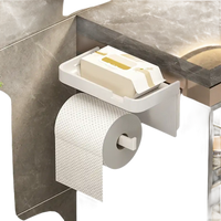 White toilet paper holder with shelf.