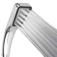 Chrome shower head with water flowing.
