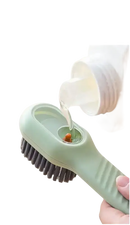 Green cleaning brush with liquid dispenser.