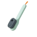 Light green cleaning brush with gray bristles and orange loop.