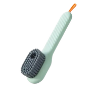Light green cleaning brush with gray bristles and orange loop.